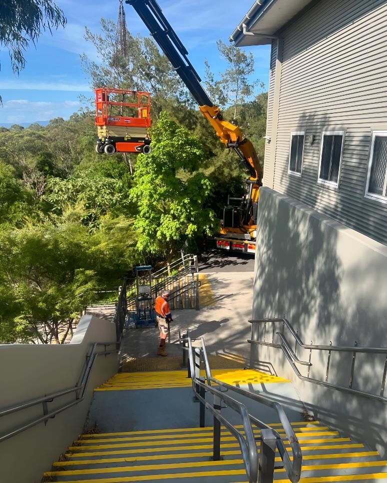 Man is Walking Down a Set of Stairs— Kiama Air Conditioning in Albion Park Rail, NSW