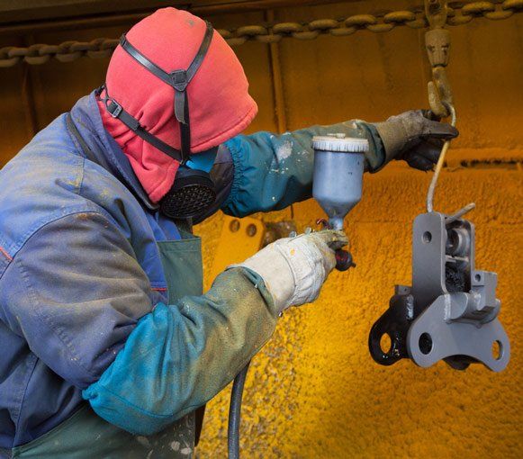 Man Painting with Spray Paint Gun — Powder coating service in Maitland, NSW