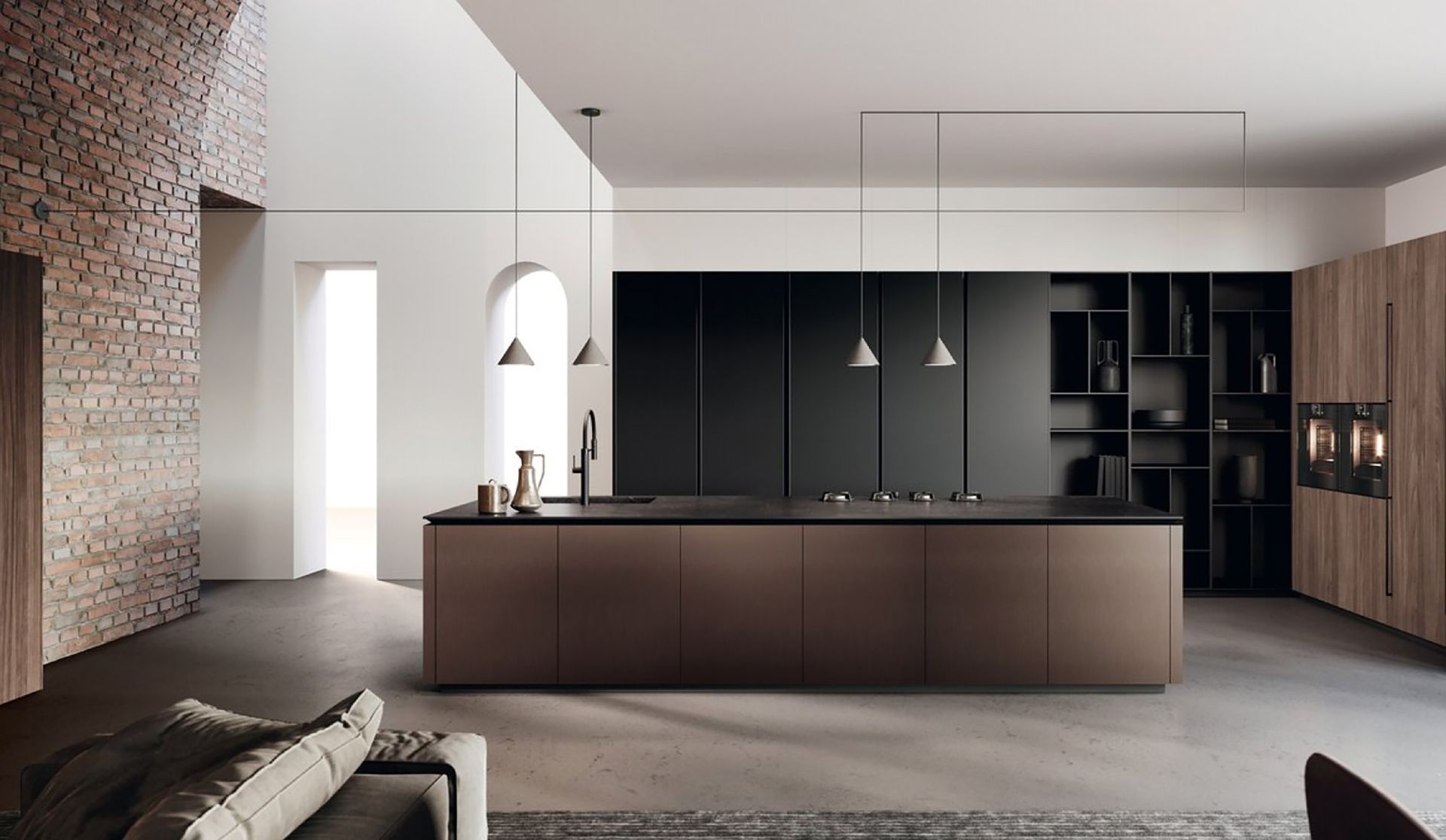 Cucina moderna e minimalista con isola scura, lampade a sospensione, mobili in legno e pareti in pietra.