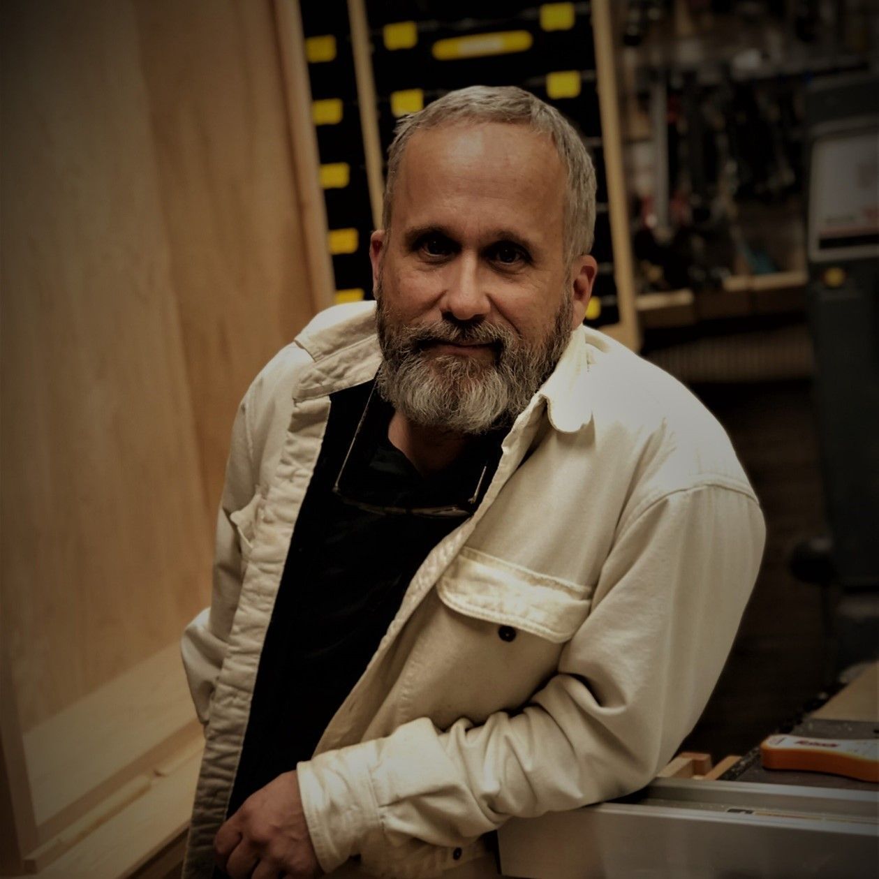 A man with a beard wearing a white jacket
