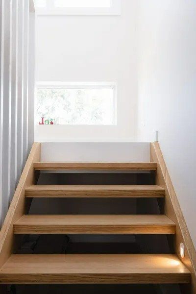 A Wooden Staircase Leading up To the Second Floor of A House — Blue Horizon Projects in Long Jetty, NSW