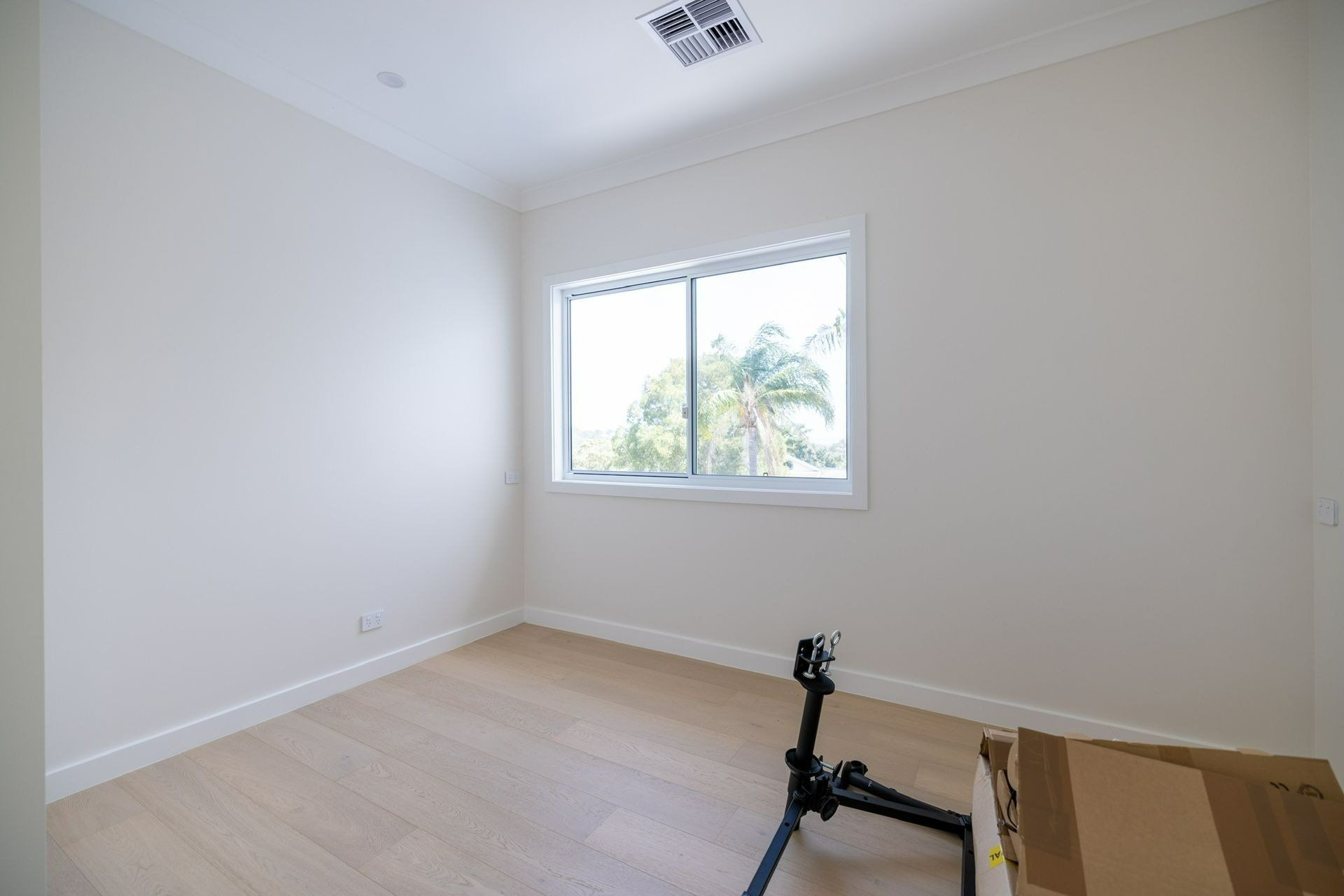 An Empty Room with A Window and A Bicycle Stand in It — Blue Horizon Projects in Killarney Vale, NSW