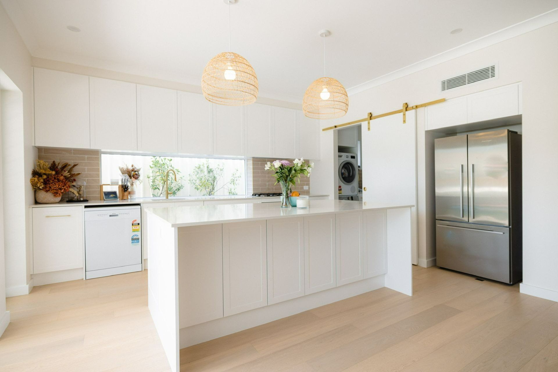 A Kitchen with White Cabinets , Stainless Steel Appliances , and A Large Island — Blue Horizon Projects in Hunter Valley, NSW