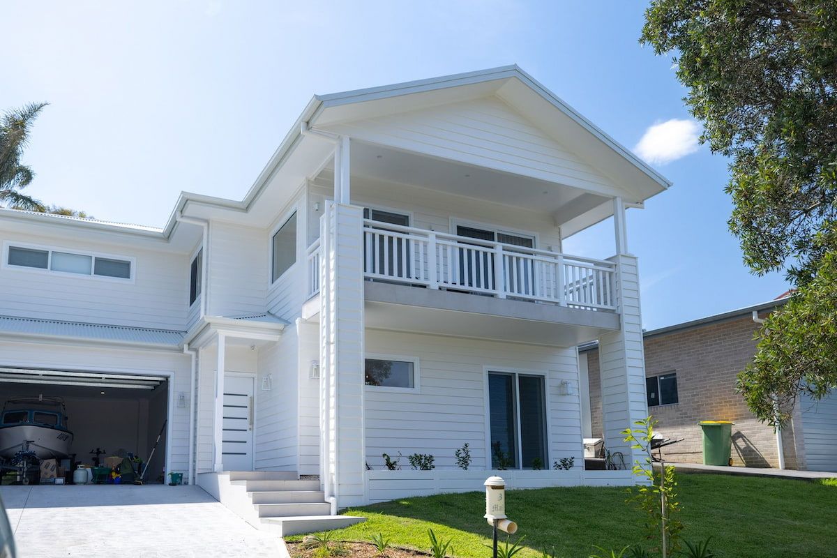A Large White House with A Garage and A Balcony — Blue Horizon Projects in Killarney Vale, NSW