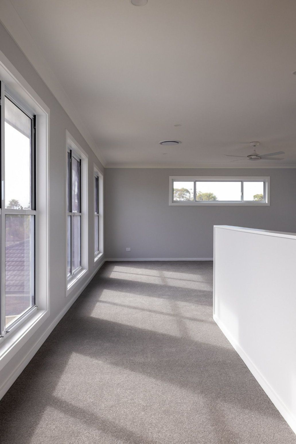 An Empty Room with A Lot of Windows and A Ceiling Fan — Blue Horizon Projects in Hunter Valley, NSW