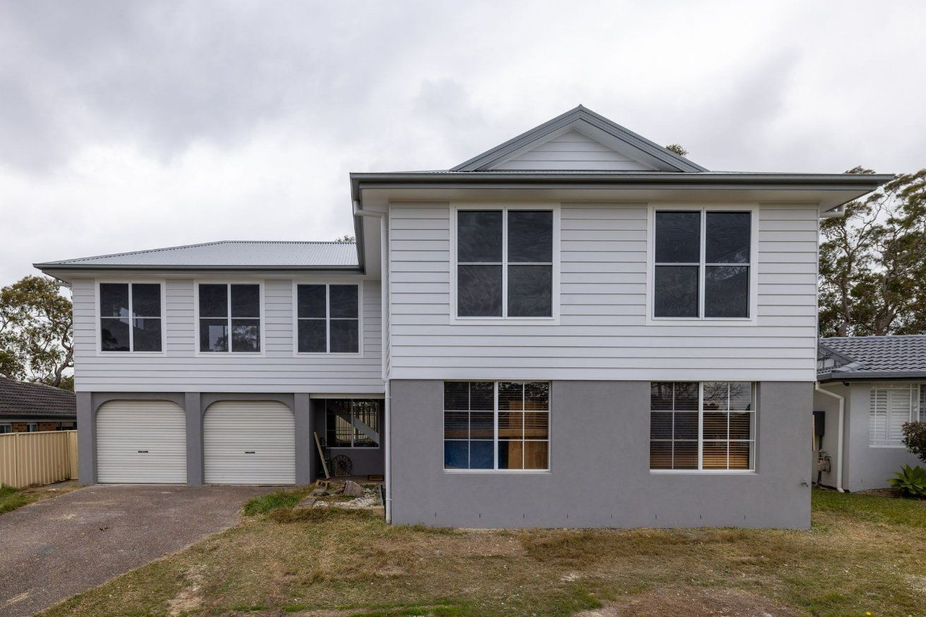 A Large White House with A Lot of Windows — Blue Horizon Projects in Killarney Vale, NSW