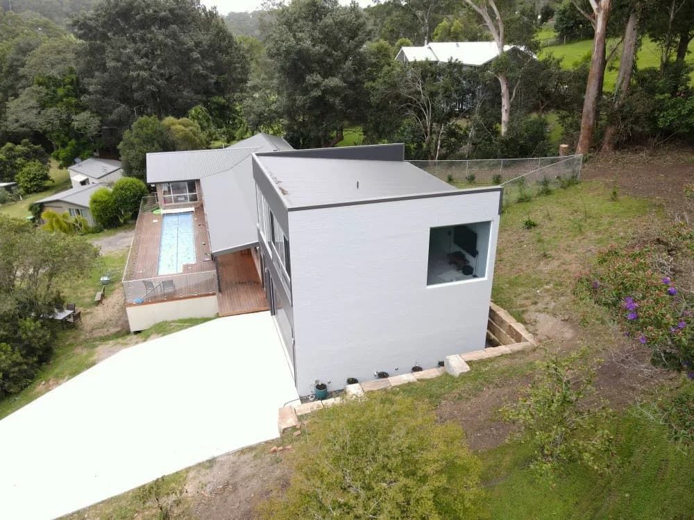 An Aerial View of A Modern House with A Swimming Pool — Blue Horizon Projects in Bateau Bay, NSW
