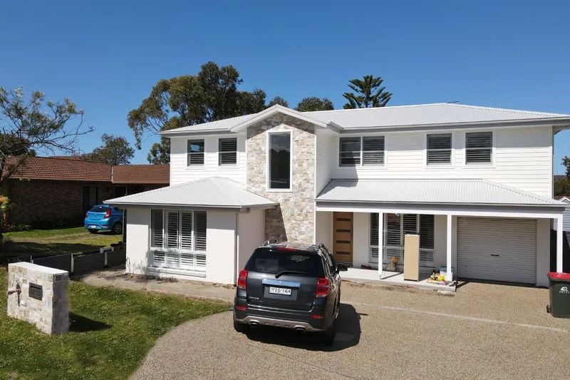 A Car Is Parked in Front of A Large White House — Blue Horizon Projects in Bateau Bay, NSW