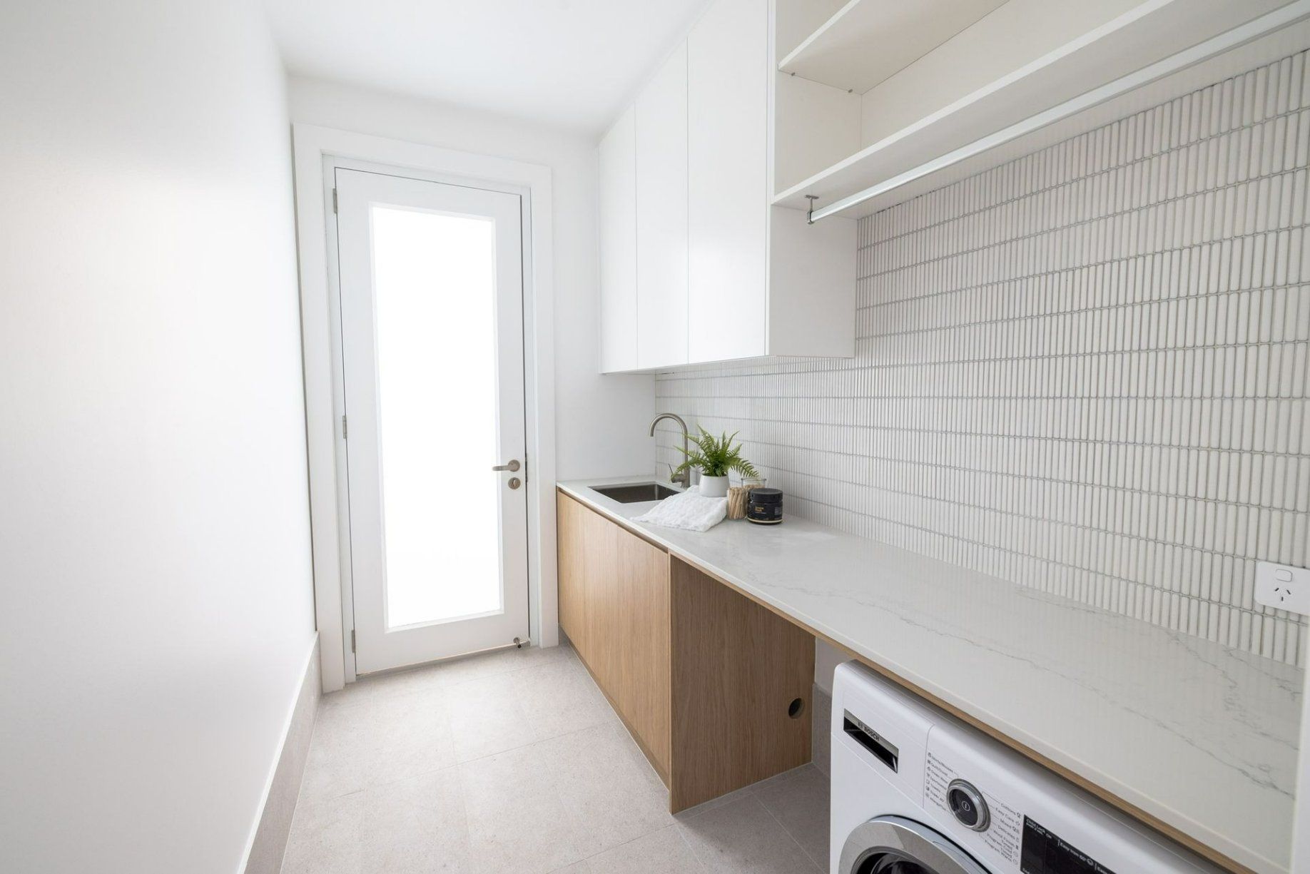 A Laundry Room with A Washing Machine and A Sink — Blue Horizon Projects in Tumbi Umbi, NSW