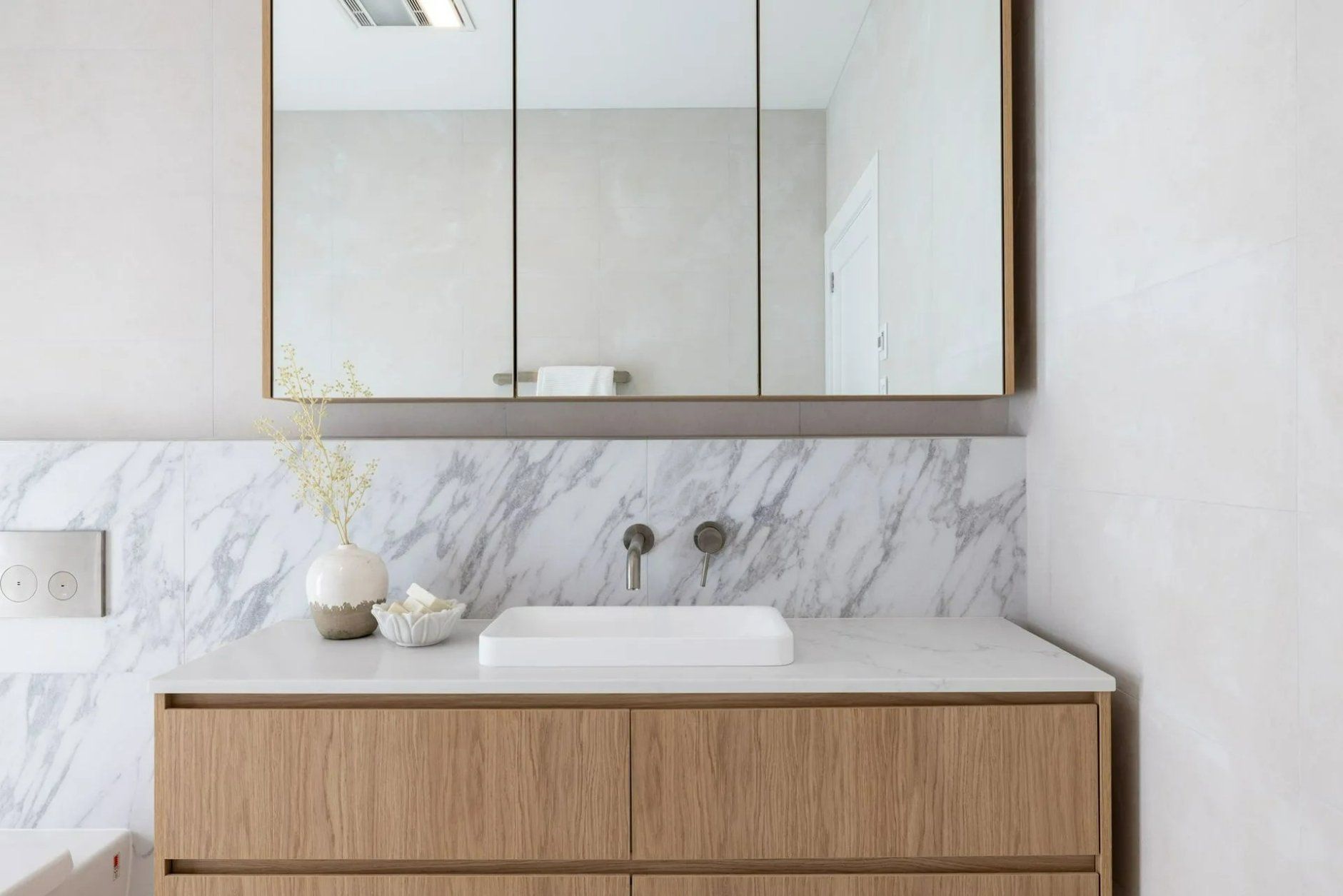 A Bathroom with A Sink, Mirror and Wooden Cabinets — Blue Horizon Projects in Wyong, NSW