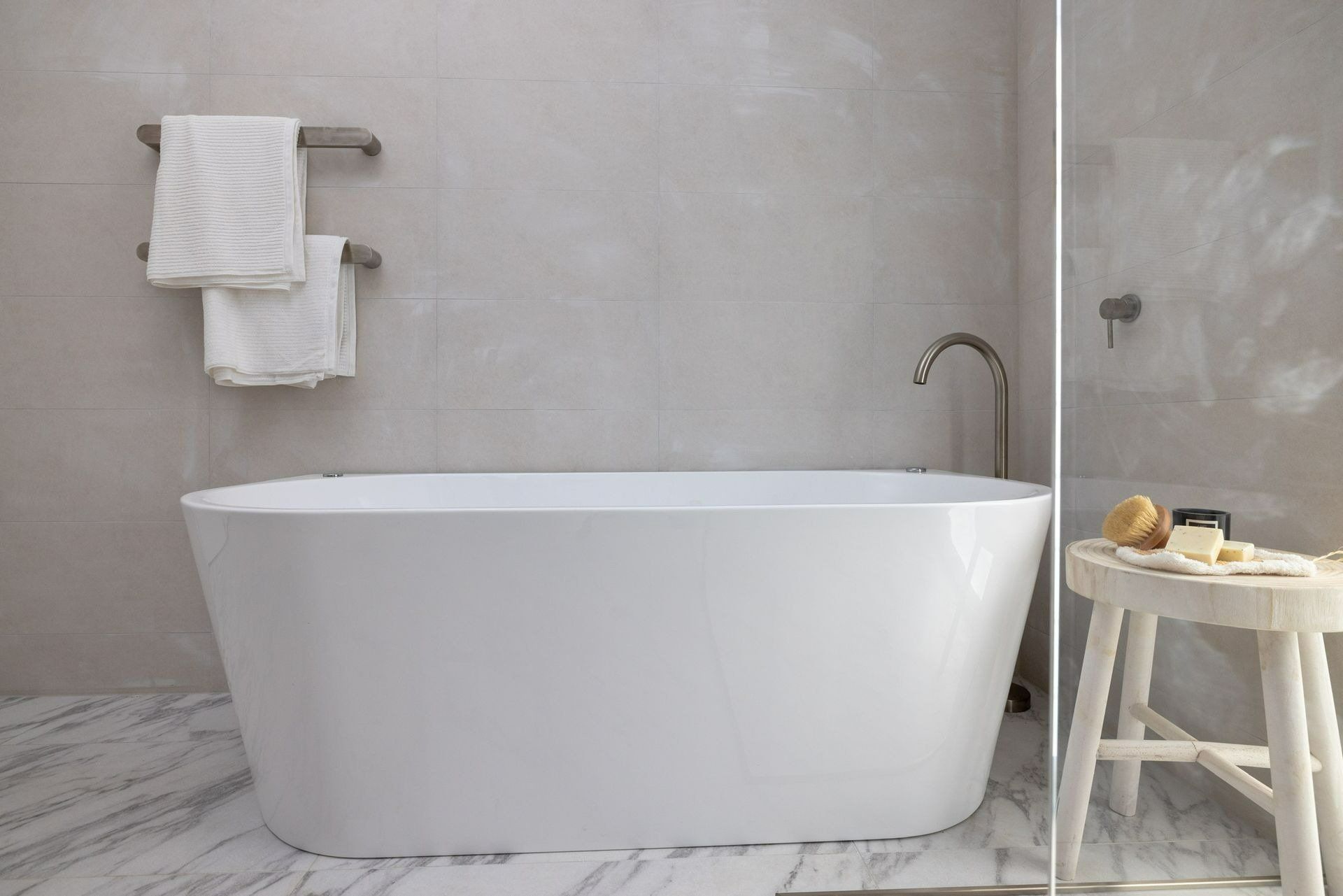 There Is a Bathtub in The Bathroom Next to A Stool — Blue Horizon Projects in Wyong, NSW