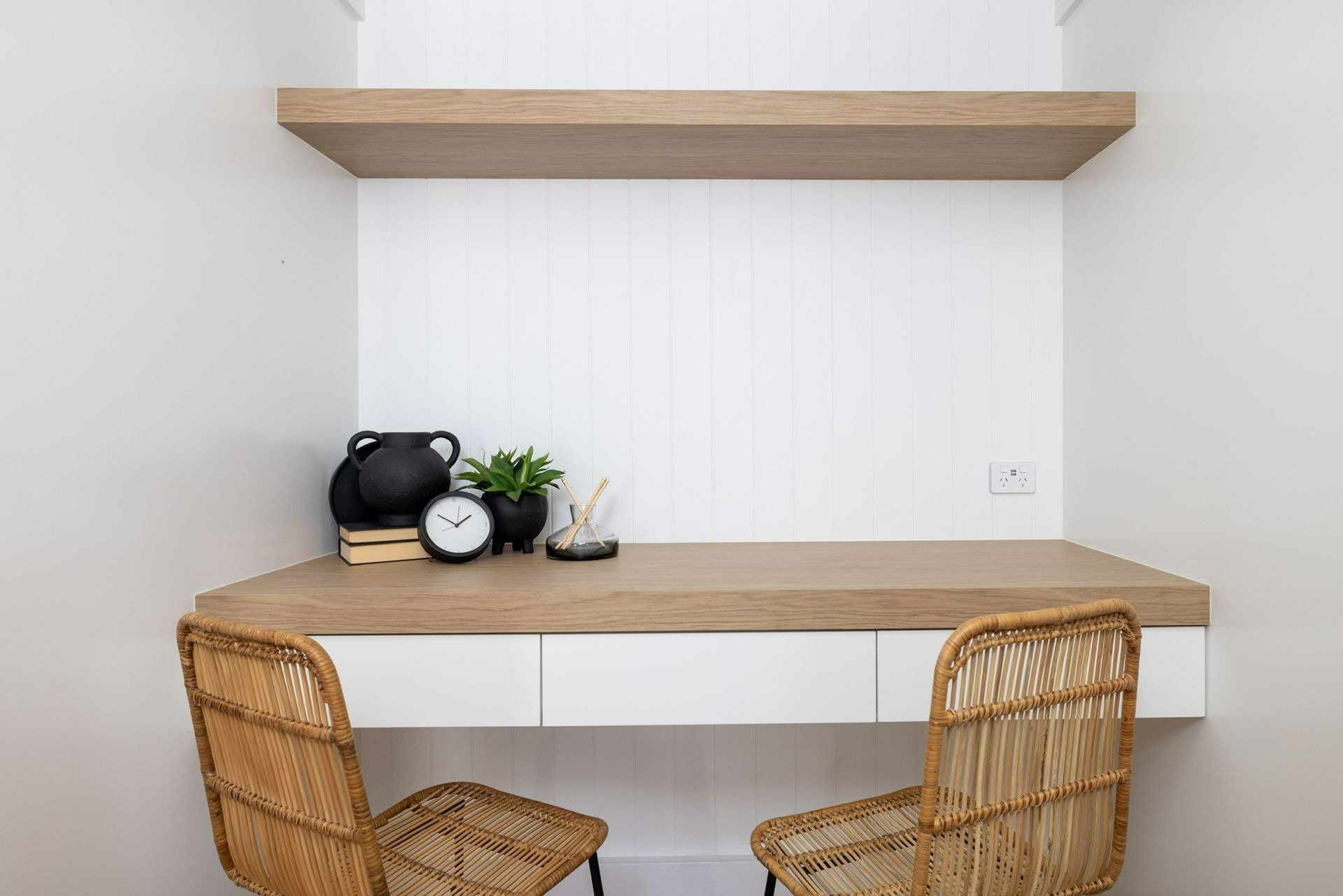 There Is a Desk with Two Chairs and A Clock on It — Blue Horizon Projects in Wyong, NSW