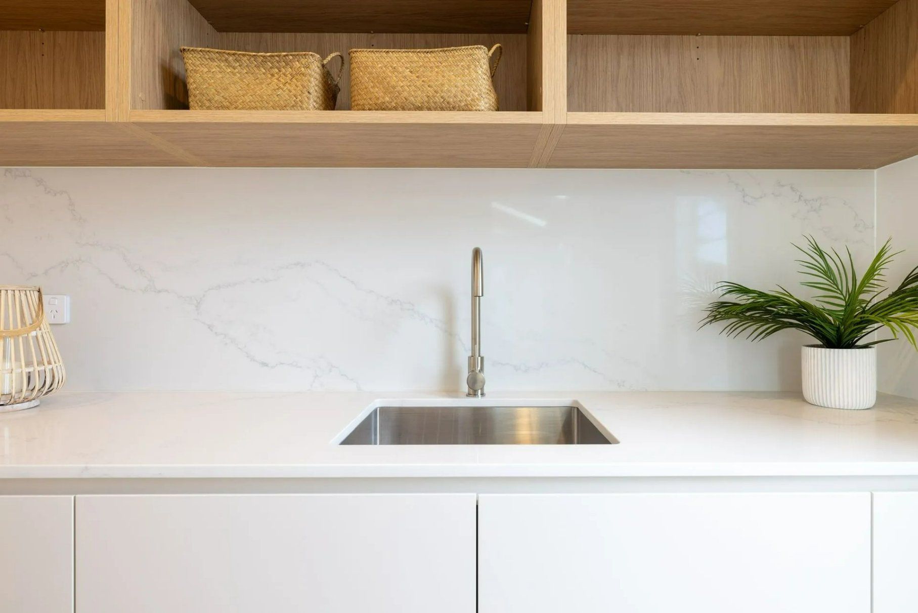A Kitchen with A Sink and A Plant on The Counter — Blue Horizon Projects in Tumbi Umbi, NSW