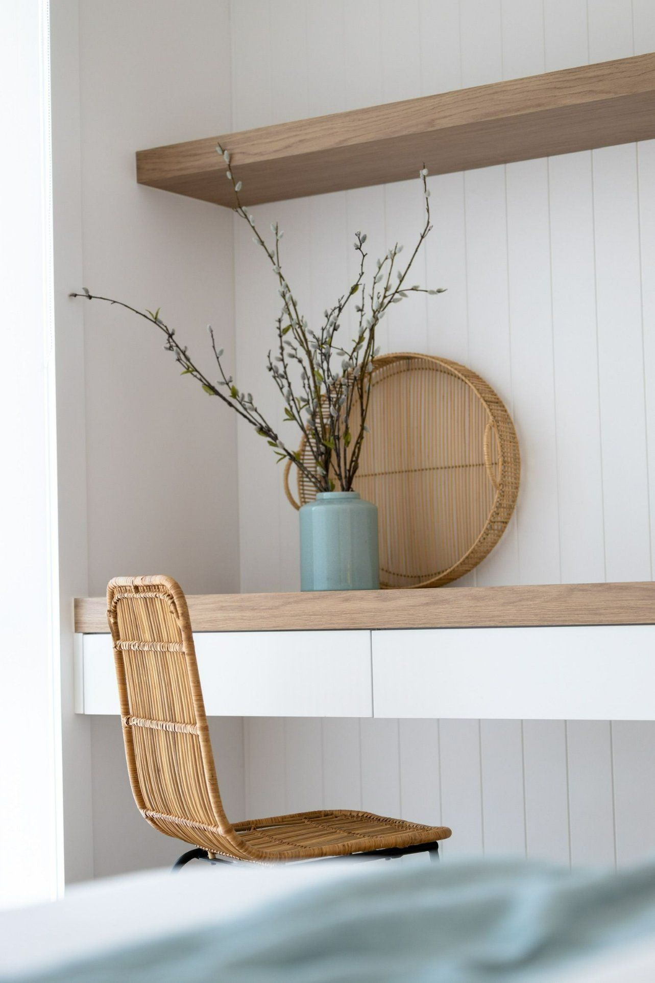 A Desk with A Wicker Chair and A Vase of Flowers on It — Blue Horizon Projects in Toowoon Bay, NSW