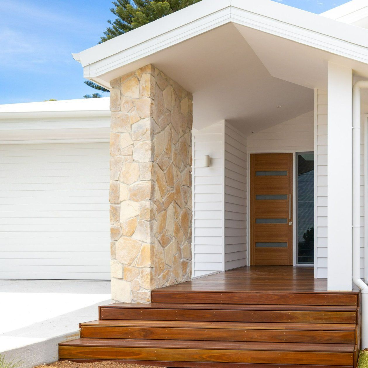 A White House with A Wooden Porch and Stairs — Blue Horizon Projects in Lake Macquarie, NSW