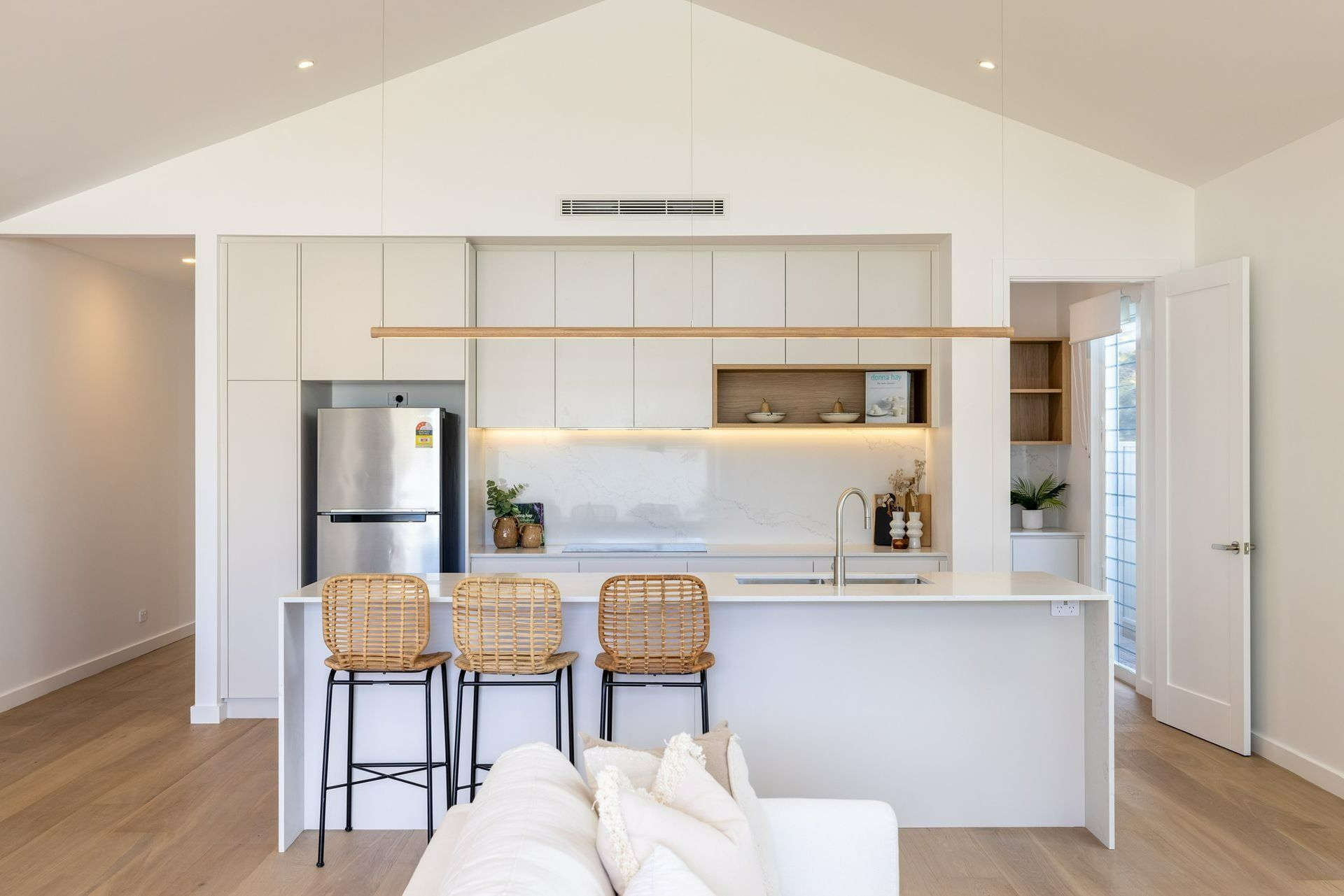 A Kitchen with White Cabinets and A Stainless Steel Refrigerator — Blue Horizon Projects in North Avoca, NSW