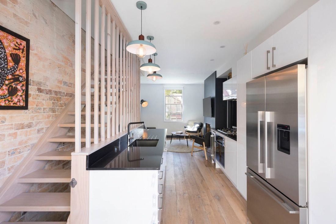 A Modern Kitchen Featuring a Sleek Black Countertop — Blue Horizon Projects in Bateau Bay, NSW 