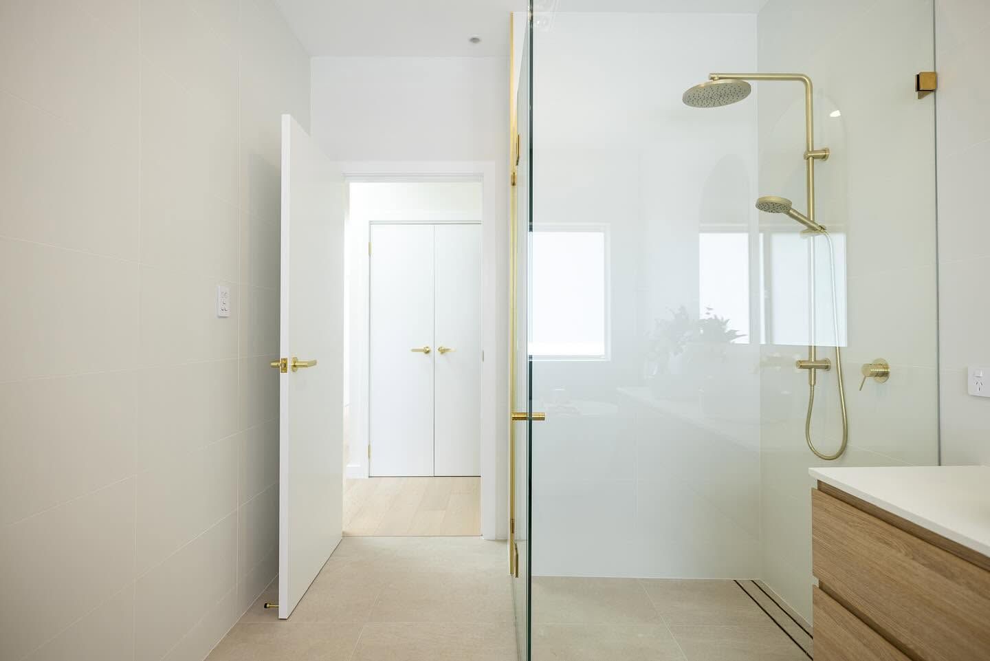 Modern Bathroom With Glass Shower, Brass Fixtures, White Door — Blue Horizon Projects in Berkeley Vale, NSW