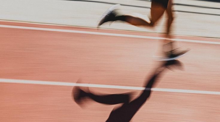 Woman running on track. athletic track.