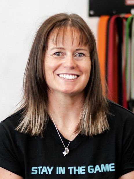 Woman smiling, wearing a black shirt, with 