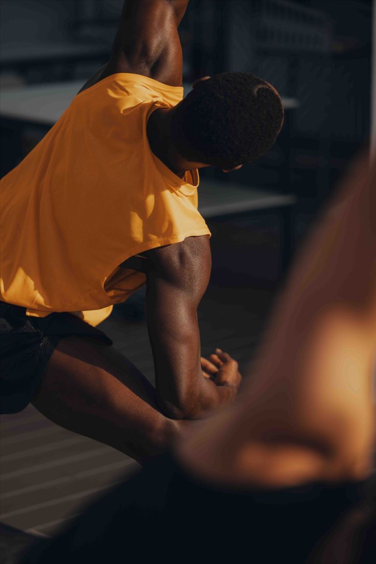 Hands performing a forearm massage on a person lying down, in a soft-lit setting