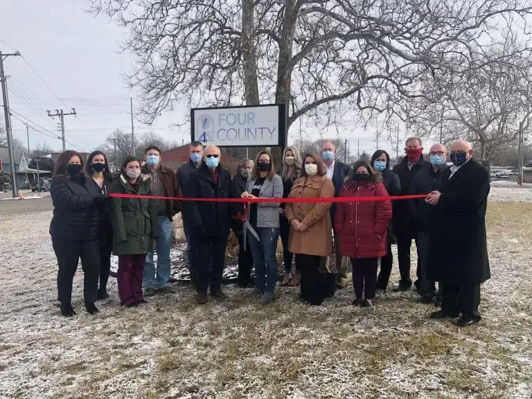 A group of people standing in a snowy field outside a 