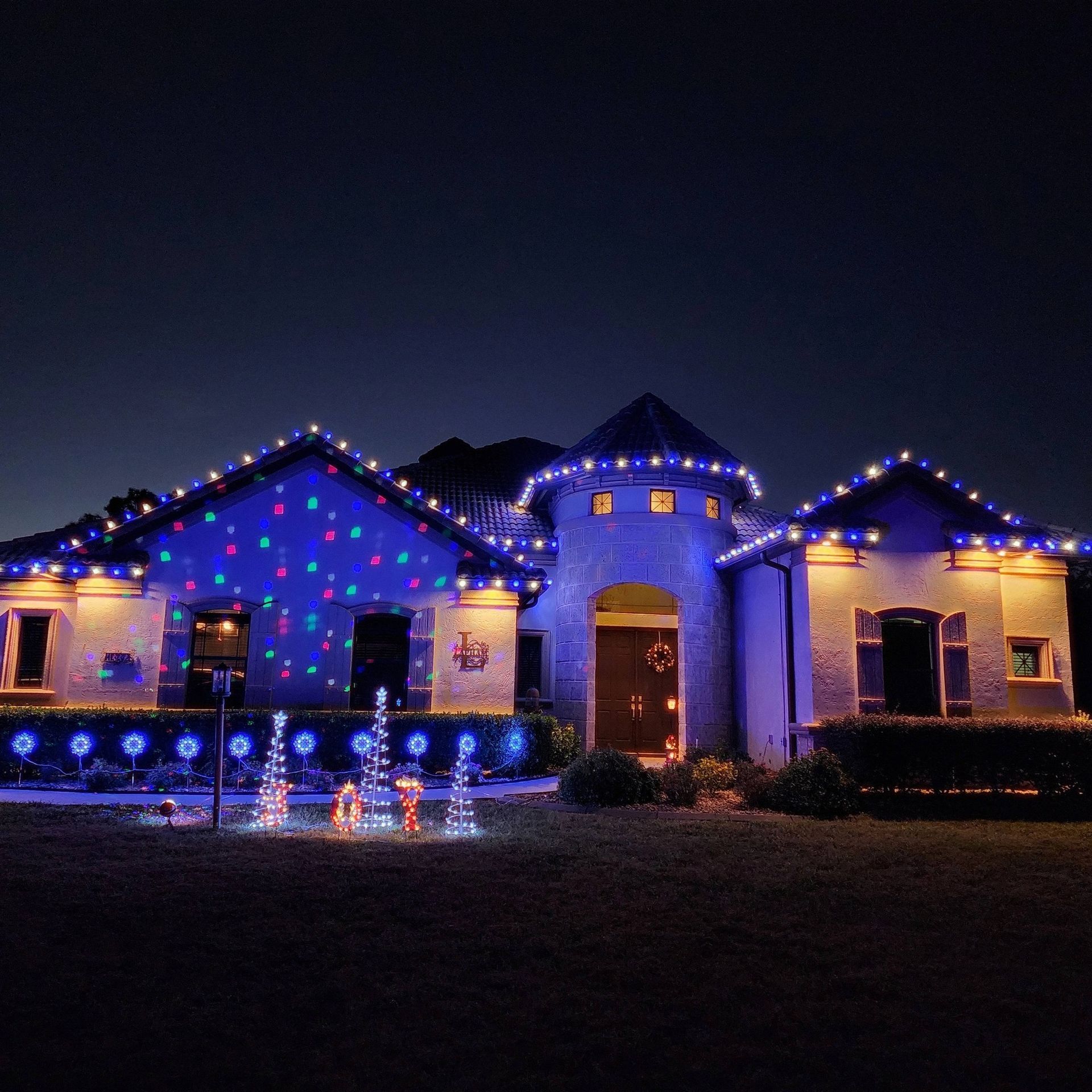 House decorated with colorful Christmas lights at night
