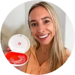 Smiling woman holding Invisalign case