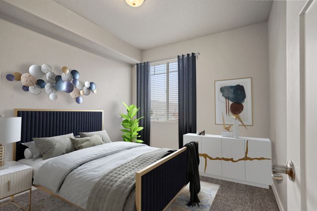 a bedroom with a bed , nightstand , dresser and window .