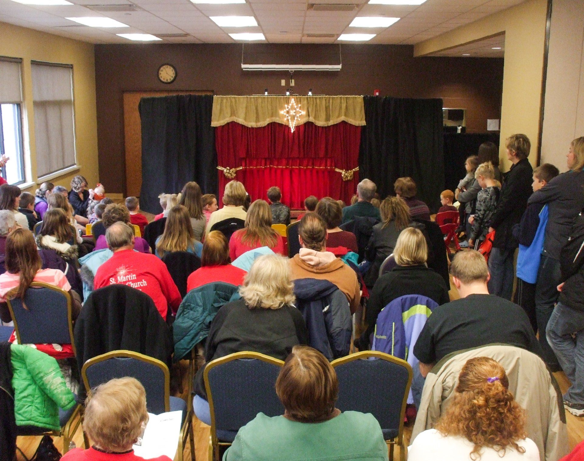 YMCA audience anticipates the opening curtain