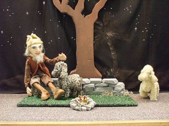 shepherd and sheep marionettes  close to fire scene