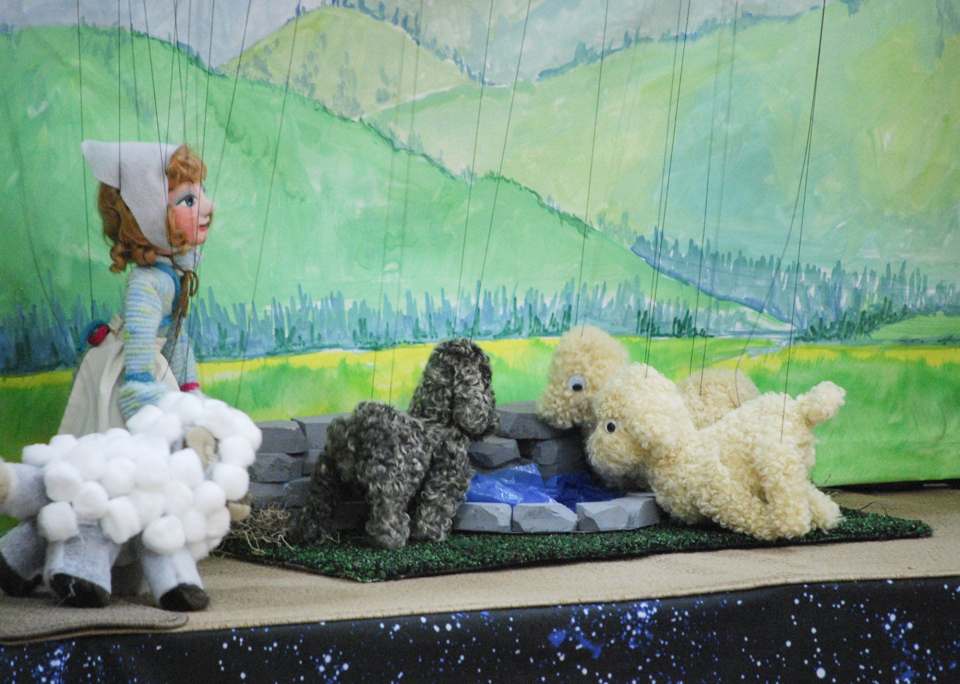 Sheep marionettes drinking at the waterhole