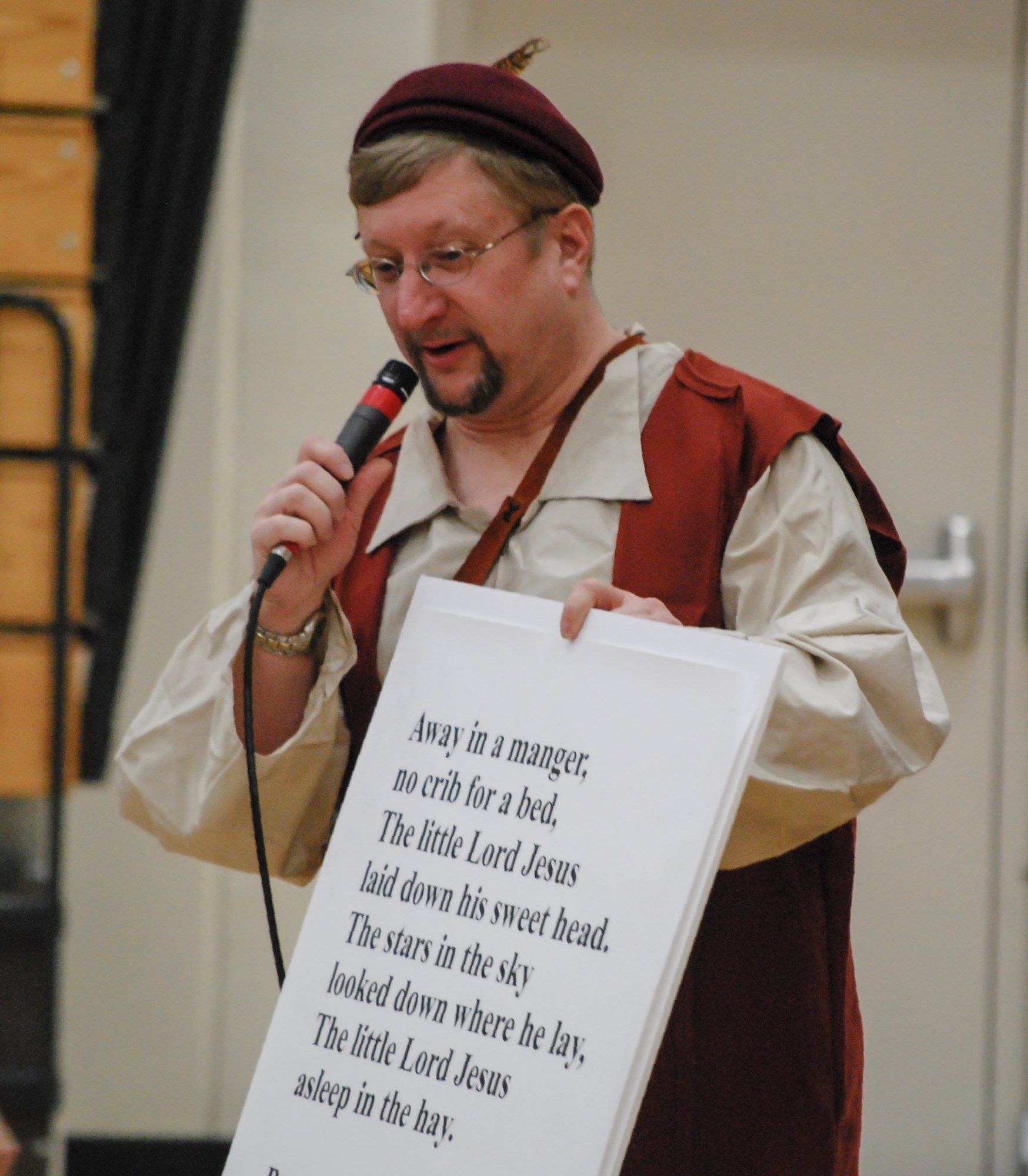 Mr. Dave holds up poster with words to closing song