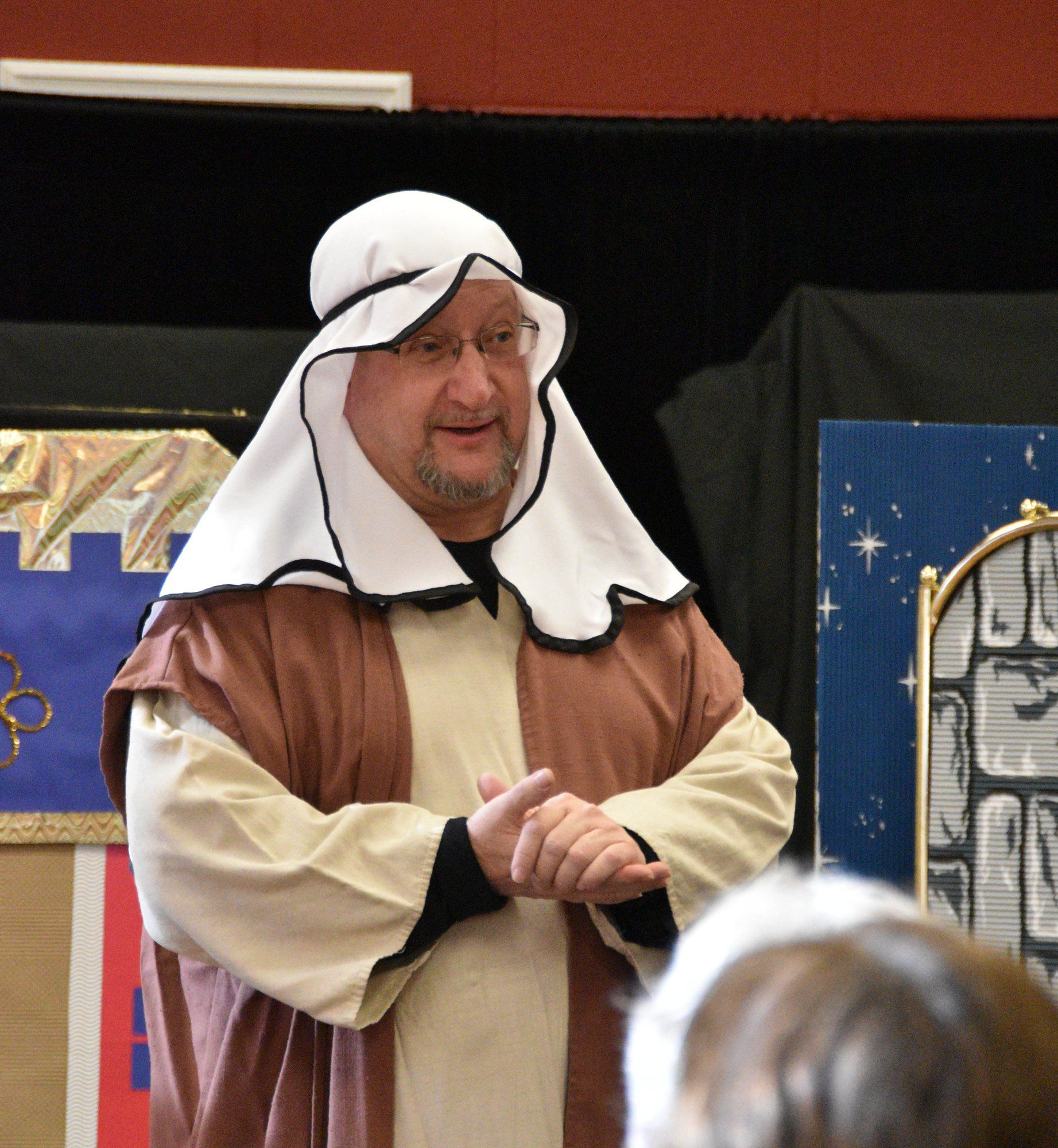 Mr. Dave, our director, speaks to the audience dressed as a shepherd