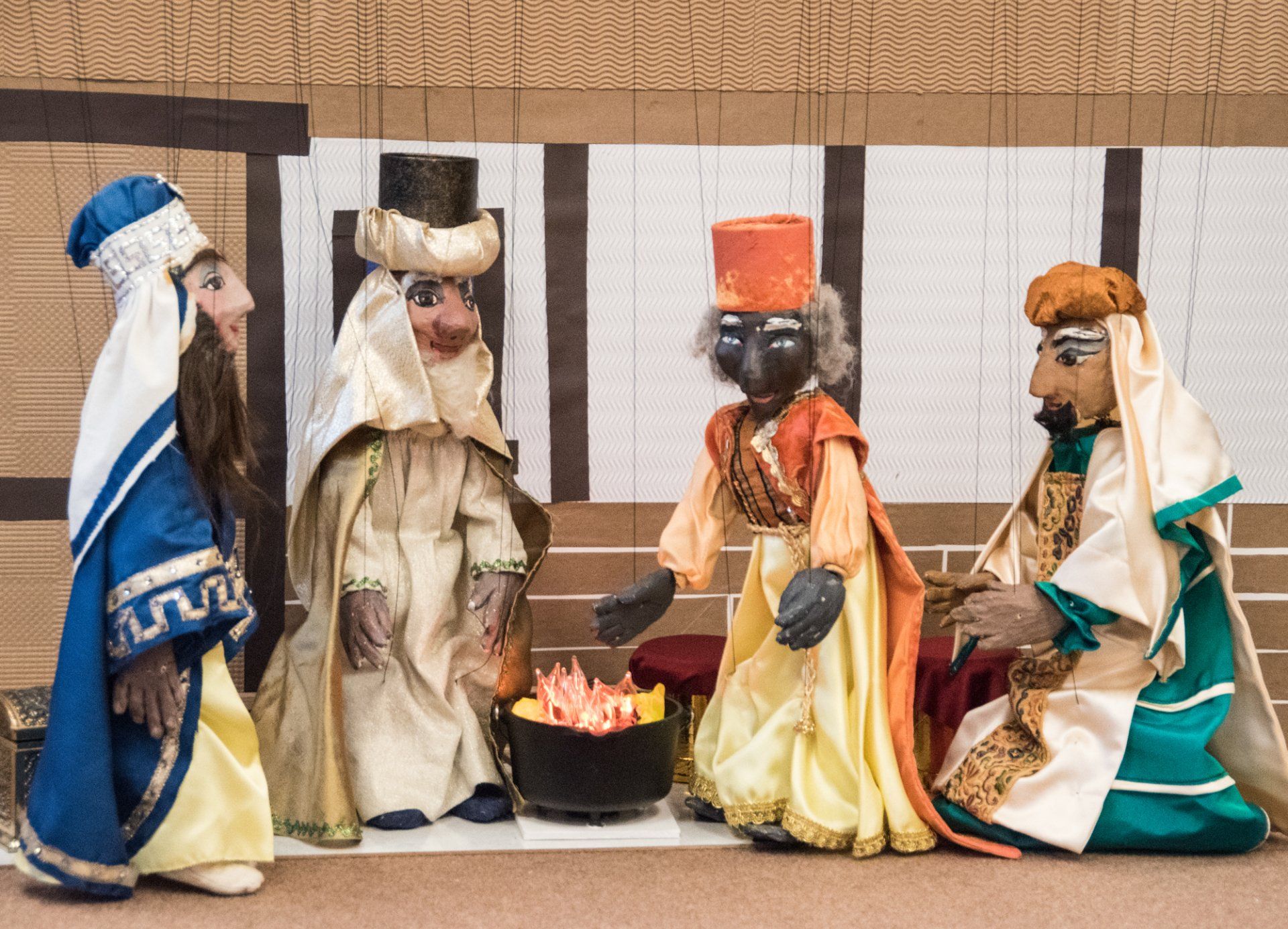 marionette wise men gather around the fire