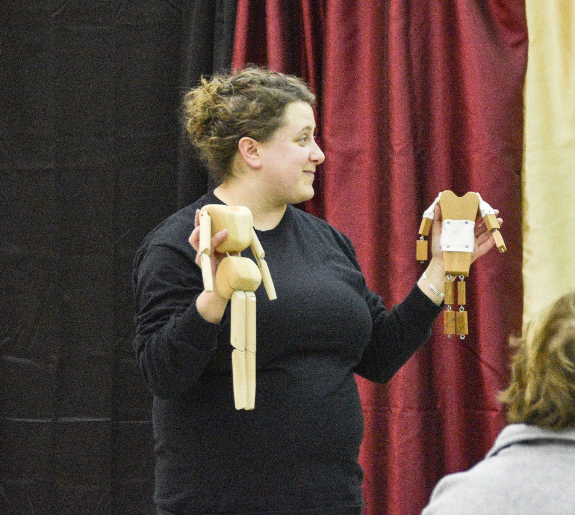 Miss Cassie explains how puppet pieces fit together