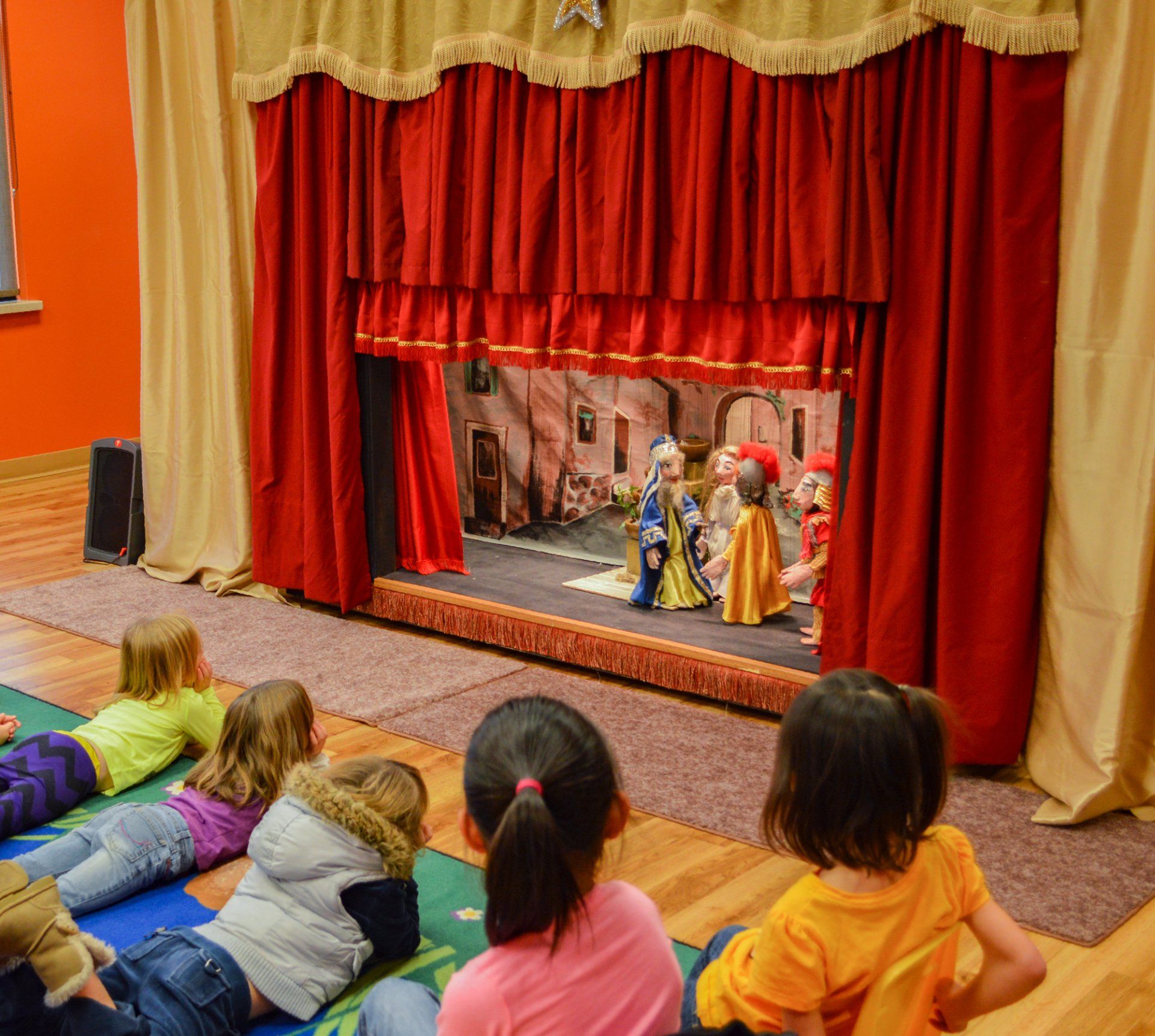 Young audience members get a comfortable view of the puppets at the Apple Creek YMCA