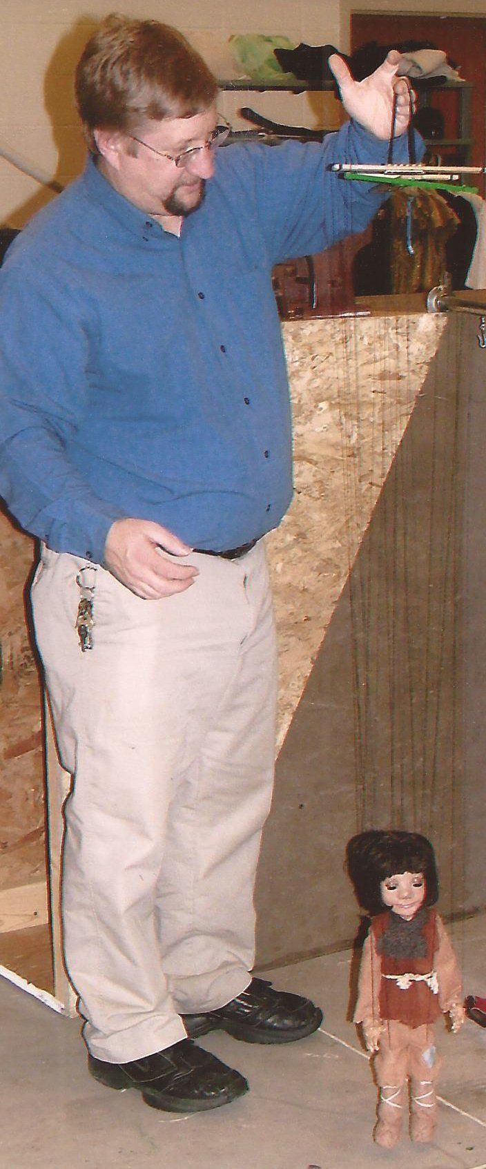 Mr. Dave holds up one of the Fox Folk Marionettes