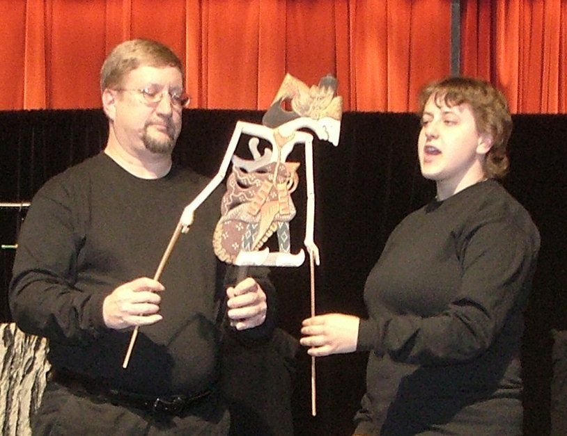 Mr. Dave and Miss Cassie hold up an Indonesian shadow puppet