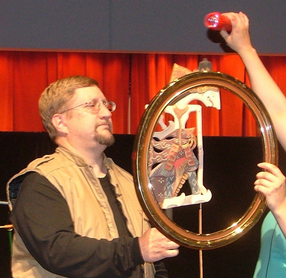 Mr Dave demonstrates how an Indonesian shadow puppet is lighted