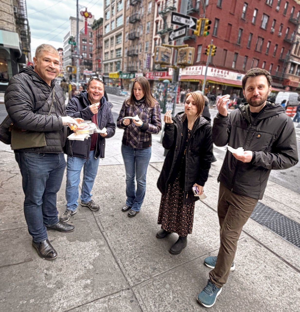 Small group food tour in Little Italy NYC with guests enjoying local street food