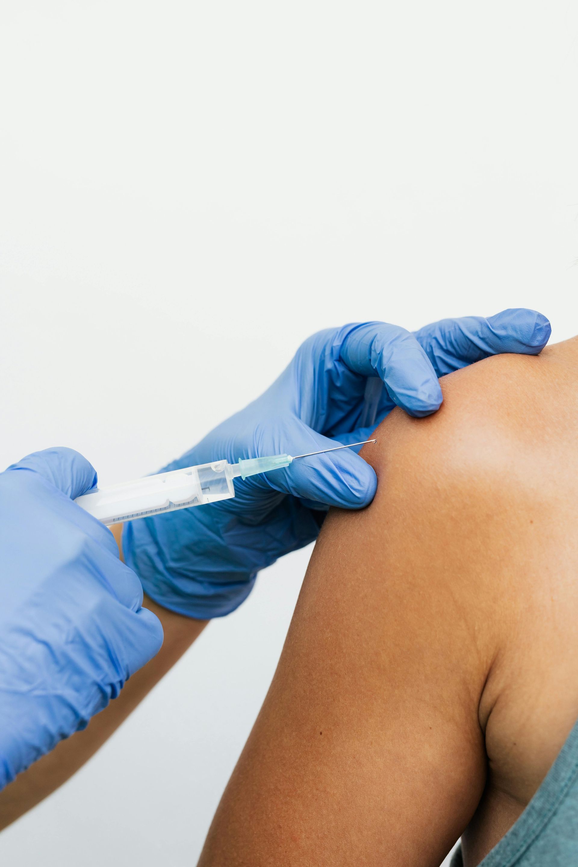 A person is getting an injection in their arm.