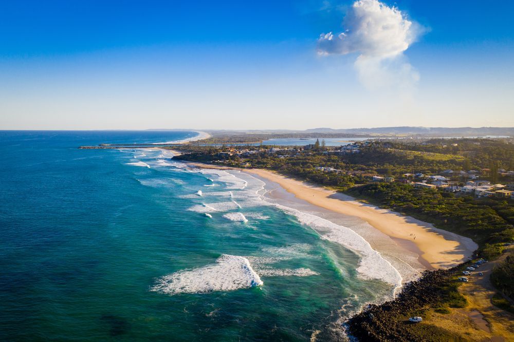 An Aerial View of a Beach With Waves Crashing on the Shore — Norcoast Diggers in Ballina, NSW