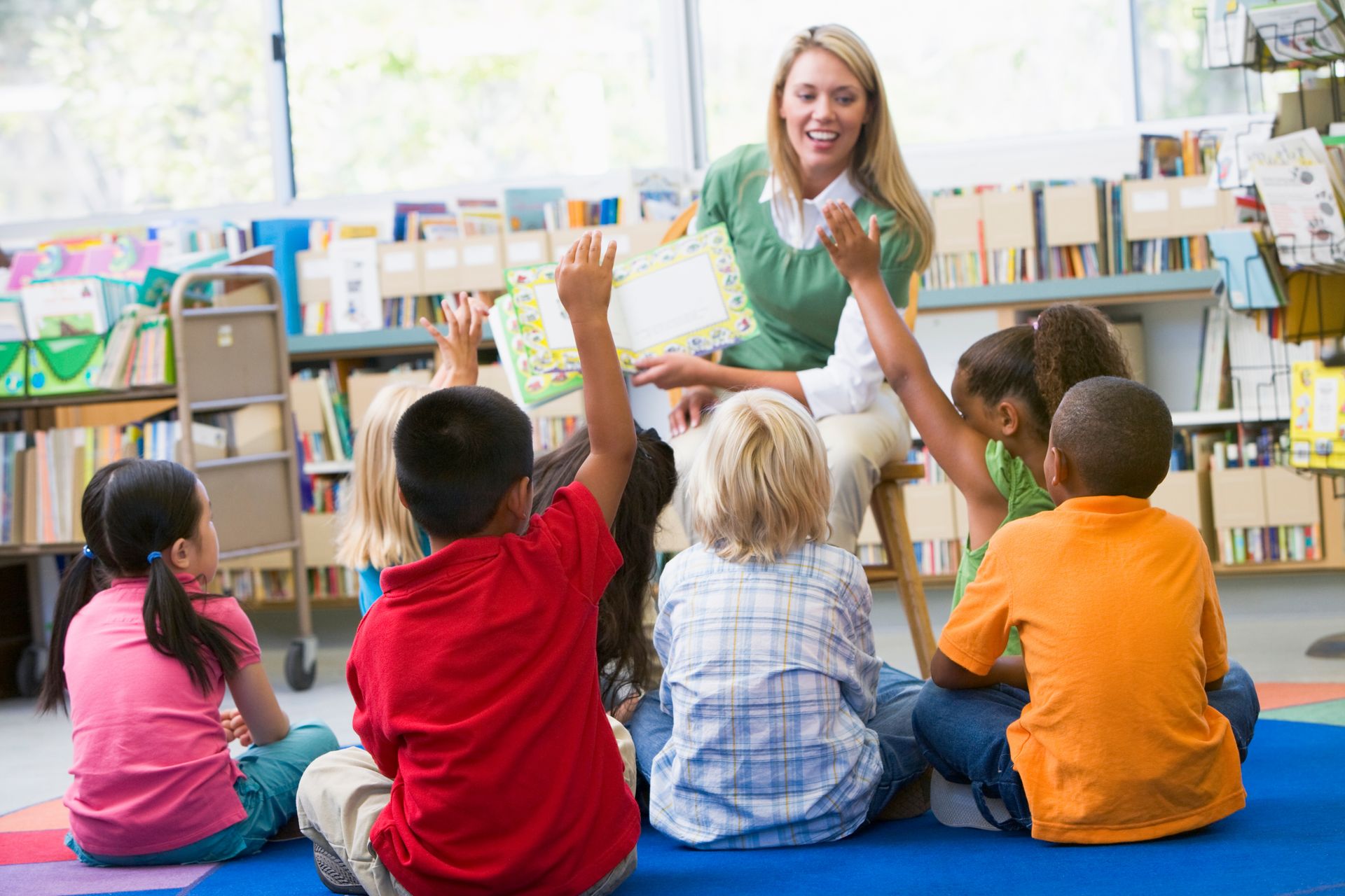WOMAN SHOWING CHILDREN BOOK