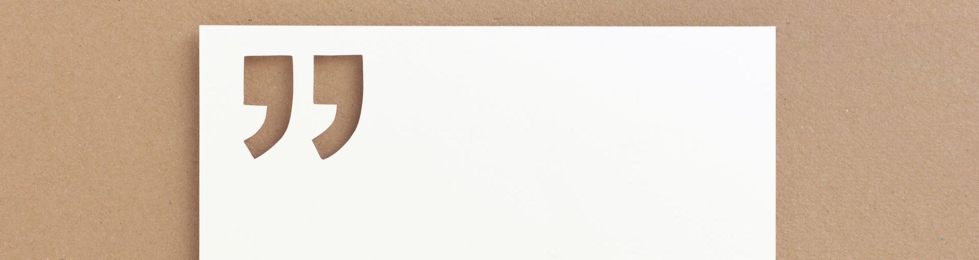 a piece of paper with a quotation mark cut out.