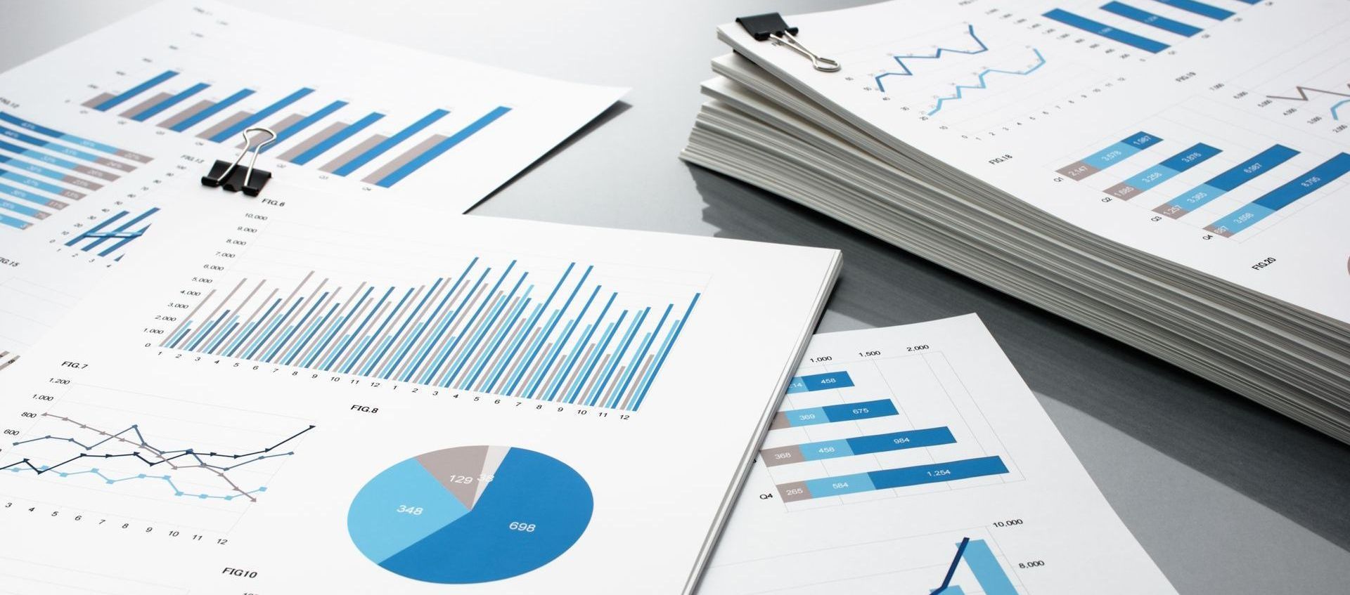 a stack of papers labeled with graphs and statistics.