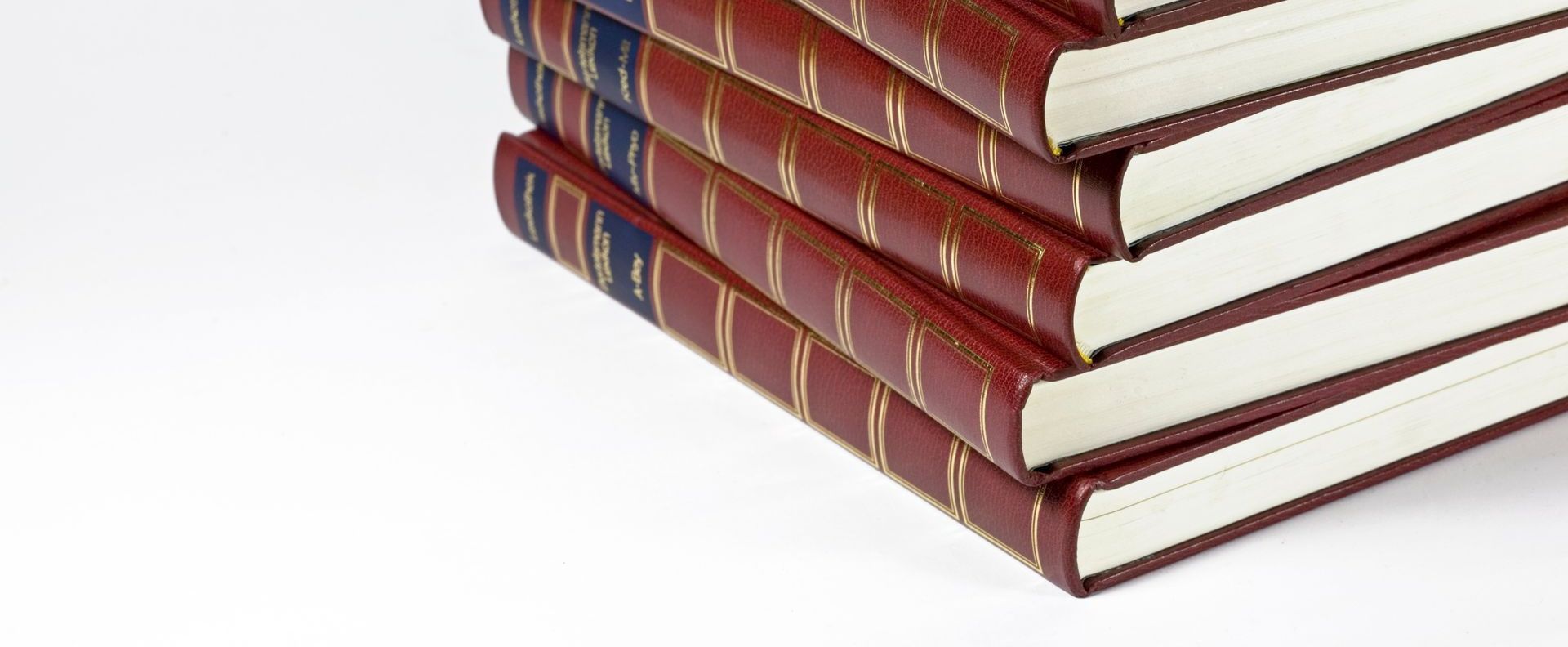 a stack of hardbound almanacs with gold foiled spines.