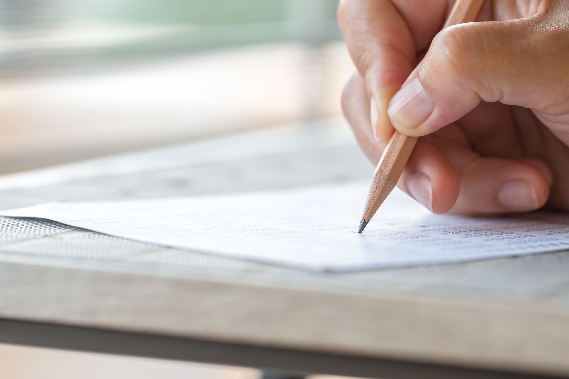 Close-up of a hand taking a test.
