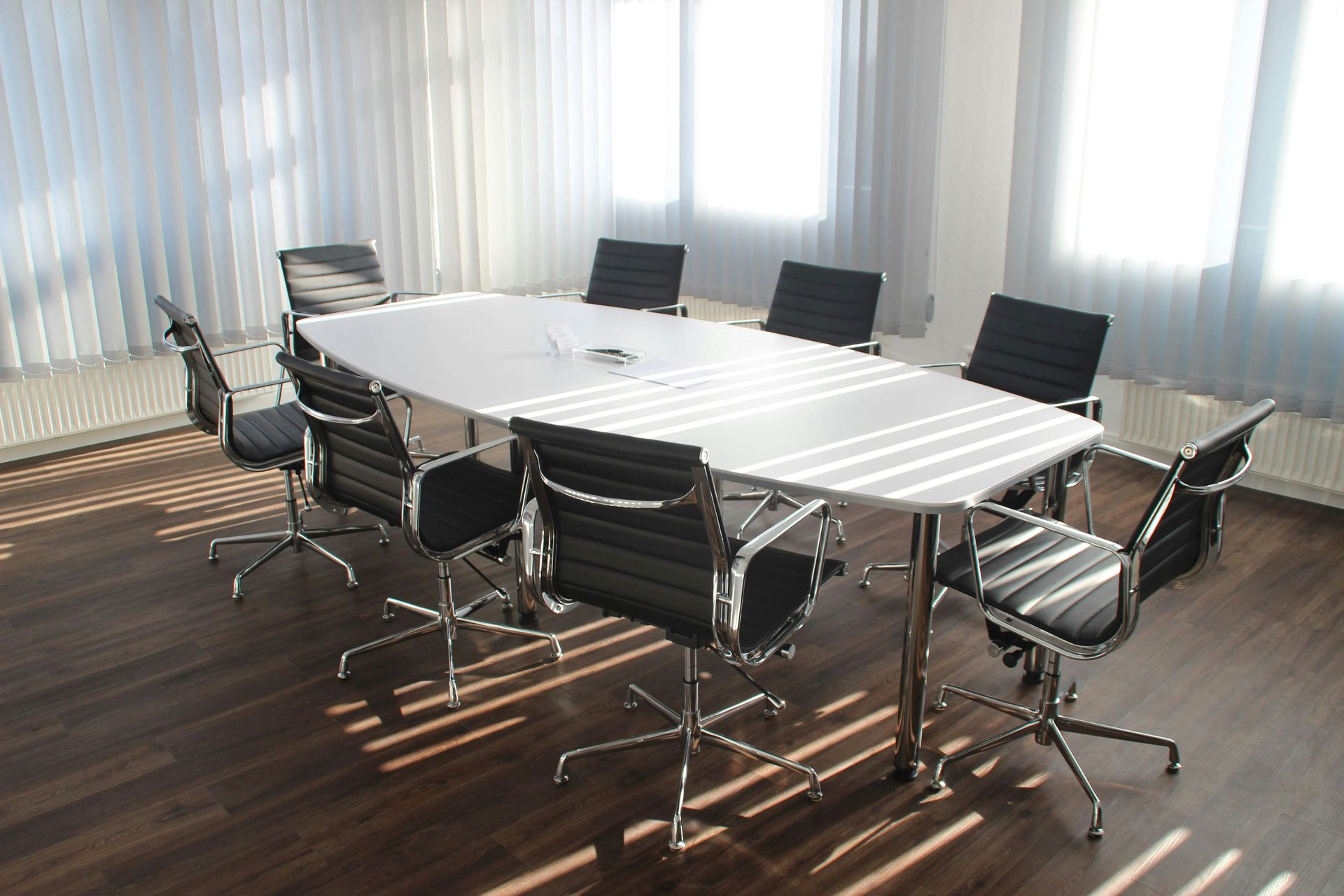 PHOTO OF MEETING ROOM TABLE WITH CHAIRS