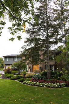 A large house with a lot of trees in front of it.